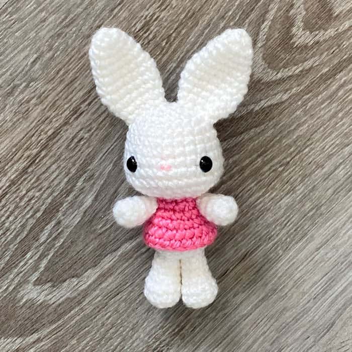 white bunny amigurumi with a pink dress